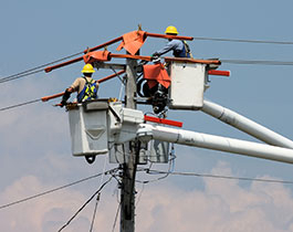 People working on a telephone pole